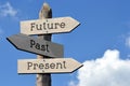 Future, past, present - wooden signpost with three arrows Royalty Free Stock Photo