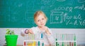 Future scientist. Explore and investigate. School lesson. Girl cute school pupil play with test tubes and colorful Royalty Free Stock Photo