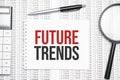 Future trends text on paper with calculator,magnifier ,pen on the graph background Royalty Free Stock Photo