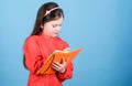 Future writer having literature class. Adorable small child writing literature report. Cute little girl holding book in Royalty Free Stock Photo