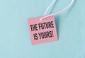 The Future Is Yours Text on Pink Paper Card on Blue Background