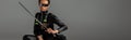 Futuristic african american woman in glasses with sword on grey, panoramic shot Royalty Free Stock Photo