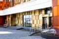 Futuristic building facade with perforated relief for lounge balcony zone and tiled brown colorful surface. Flowing