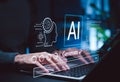 Futuristic concept of artificial intelligence technology, showing hands typing on a laptop with digital interface elements like AI Royalty Free Stock Photo
