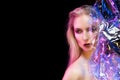 Futuristic conceptual portrait of a beautiful girl covered by wrinkled transparent plastic colored by blue and red lights Royalty Free Stock Photo