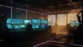 Futuristic control room with multiple glowing computer monitors and figures working technology Royalty Free Stock Photo