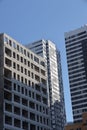 Futuristic design part of skyscrapers against a clear blue sky. Abstract facade design. Glass and metal in modern urban Royalty Free Stock Photo