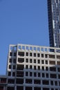 Futuristic design part of skyscrapers against a clear blue sky. Abstract facade design. Glass and metal in modern urban Royalty Free Stock Photo