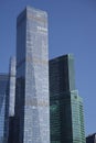 Futuristic design part of skyscrapers against a clear blue sky. Abstract facade design. Glass and metal in modern urban