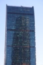 Futuristic design part of skyscrapers against a clear blue sky. Abstract facade design. Glass and metal in modern urban Royalty Free Stock Photo