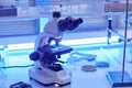 Futuristic electronic microscope on laboratory workstation in neon light