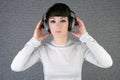 Futuristic fashion woman hearing music headphones