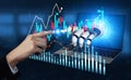 Futuristic financial analysis concept featuring robotic hand interacting with digital charts and data presentation on a Royalty Free Stock Photo