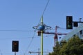 Futuristic Globe with construction cranes in background surrounded by red and green traffic lights.