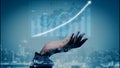 Futuristic Hand Supporting Digital Growth Chart with Data Visualizations Over Cityscape Background in Blue Tones Copula Royalty Free Stock Photo