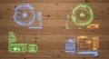 Futuristic hud elements in blue, green, and orange displayed on a wooden panel background Royalty Free Stock Photo