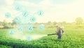 Futuristic innovative technology pictogram and a farmer with a mist blower sprayer walks through the potato plantation. Treatment