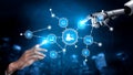 Futuristic Interaction Between Human Hand and Robotic Hand With Digital Nodes and Icons Representing Technology, Data Royalty Free Stock Photo