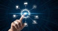 Futuristic interface with hand interacting with virtual elements and icons representing various aspects of technology and Royalty Free Stock Photo