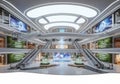 Futuristic interior of a multilevel shopping mall. Features sleek escalators connecting three Royalty Free Stock Photo