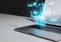 Futuristic laptop displaying glowing blue data analytics and charts Royalty Free Stock Photo