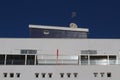 Futuristic looking detail of a modern apartment building against blue sky