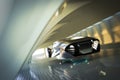 Futuristic luxury sports car hovering at high speeds through a modern interior tunnel . Royalty Free Stock Photo