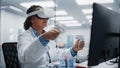 Futuristic Medical Hospital: Black Female Neurosurgeon Wearing Virtual Reality Headset Uses