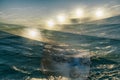 Futuristic mystical seascape with mannequin face under water and five suns