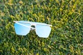 Futuristic oversized sunglasses model with blue lenses shoot outdoor closeup . Selective focus