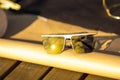 Futuristic Oversized sunglasses model with golden lenses shoot outside in a summer day closeup . Selective focus