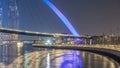 Futuristic Pedestrian Bridge over the Dubai Water Canal Illuminated at Night timelapse, UAE. Royalty Free Stock Photo