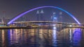Futuristic Pedestrian Bridge over the Dubai Water Canal Illuminated at Night , UAE. Royalty Free Stock Photo