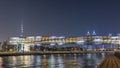 Futuristic Pedestrian Bridge over the Dubai Water Canal Illuminated at Night , UAE. Royalty Free Stock Photo