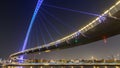 Futuristic Pedestrian Bridge over the Dubai Water Canal Illuminated at Night , UAE. Royalty Free Stock Photo