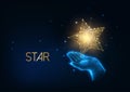 Futuristic people award, excellence concept with glow low polygonal human hand holding golden star. Royalty Free Stock Photo