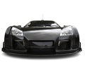 Futuristic pitch black supercar - front view extreme closeup shot