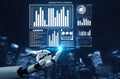 Futuristic Robot Analyzing Marketing Data and Planning Strategy with Digital Charts and Graphs in Urban Environment Royalty Free Stock Photo