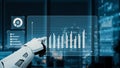 Futuristic Robot Arm Interacting with Data Visualization Interface in Modern Office Environment at Night. Auvana Royalty Free Stock Photo