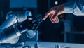 Futuristic Robot Arm Touches Human Hand in Humanity and Artificial Intelligence Unifying Gesture