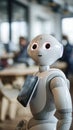 A Futuristic Robot With Glowing Eyes Holds a Tablet in a Modern Office Setting Royalty Free Stock Photo