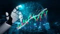 Futuristic Robot Hand Interacting with Digital Financial Data Visualization and Stock Market Chart in Urban Environment Royalty Free Stock Photo