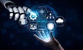 Futuristic Robot Hand Interacting with Digital Icons Representing Technology, Data, and Innovation in a Blue Background Royalty Free Stock Photo