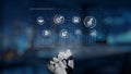 Futuristic Robot Hand Interacting with Digital Interface Featuring Business and Technology Icons in a Modern Office Royalty Free Stock Photo
