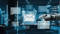 Futuristic Robot Hand Interacting with Digital Email Interface in Modern Office Setting with Cityscape Background at Royalty Free Stock Photo