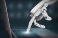 Futuristic robot hand typing on laptop keyboard
