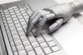 Futuristic robot hand typing and working with laptop keyboard. Mechanical arm with computer Royalty Free Stock Photo