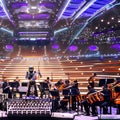 A futuristic robot orchestra performing a symphony of electronic music in a grand concert hall4, Generative AI