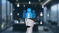 Futuristic robotic hand interacting with digital avatars in a modern office environment showcasing technology and human Royalty Free Stock Photo