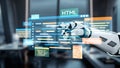 Futuristic robotic hand interacting with digital coding interface displaying various programming languages in a modern Royalty Free Stock Photo
